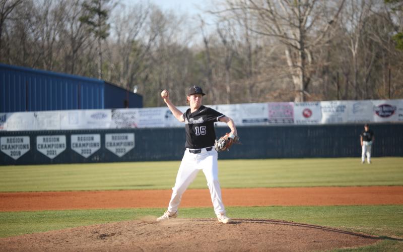 Colson Brown tries to get a runner out by throwing over to first base. (Photo by Wells)