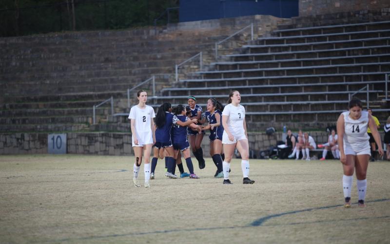 The Lady Devils swarm Victoria Medellin after she scored the game-winning goal in the second-half of extra time to beat Commerce 3-2 March 14. (Photo by Wells)