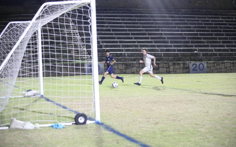 Daniel Ezqueda watches after tapping the ball into the back of the empty net (right) to finish off a first-half hat trick in Elbert’s 9-3 win over Commerce March 14. (Photo by Wells)