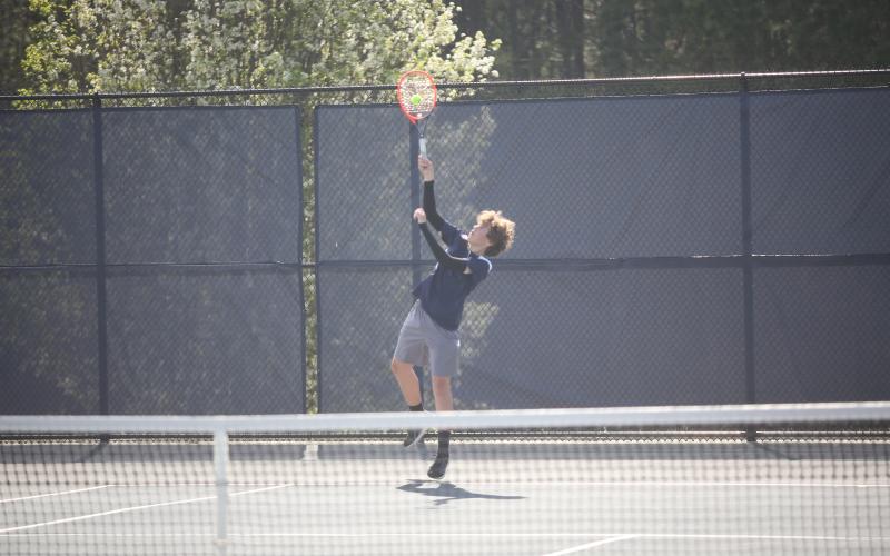 Jibi Englehardt serves the ball during the boys No. 1 doubles match against Rabun. (Photo by Wells)
