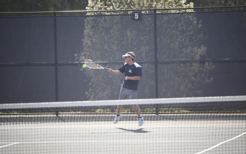 Adrian Jenkins puts power behind a shot during Elbert’s match against Rabun March 19. (Photo by Wells)