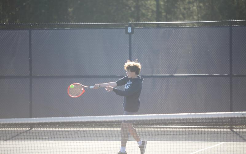 Jibi Englehardt takes a shot with the forehand during his win with partner T.J. Allen in the No. 1 doubles match over Washington-Wilkes. (Photo by Wells)