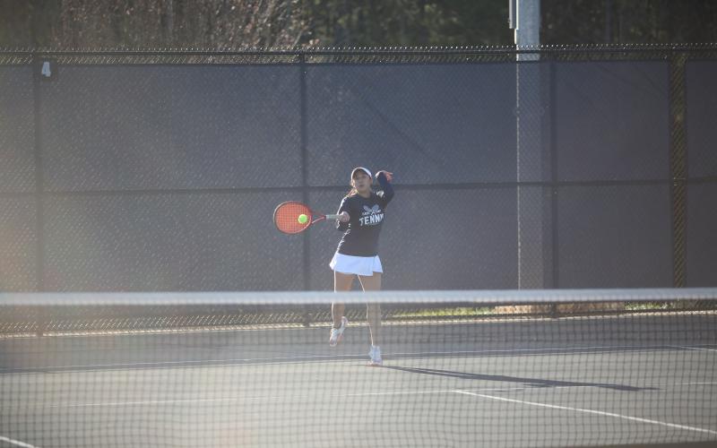 Emily Poon returns a serve during her win in the No. 1 singles match against Washington-Wilkes March 6. (Photo by Wells)