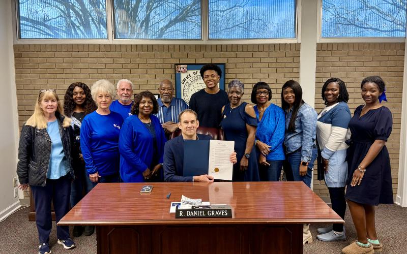 On hand for the signing of the proclamation for Colon Cancer Awareness Month are (L-R) Susie Payne, Sherell Eberhardt, Ellen and Merrill Franklin, Edna Eberhardt, Bobby G. Hunt, Mayor Daniel Graves, Travis Allen, Pam Allen, Margie Hunter, Anissa McIntosh, Kirsten Porter and Jurnee Porter. (Photo submitted by Devan Seawright)