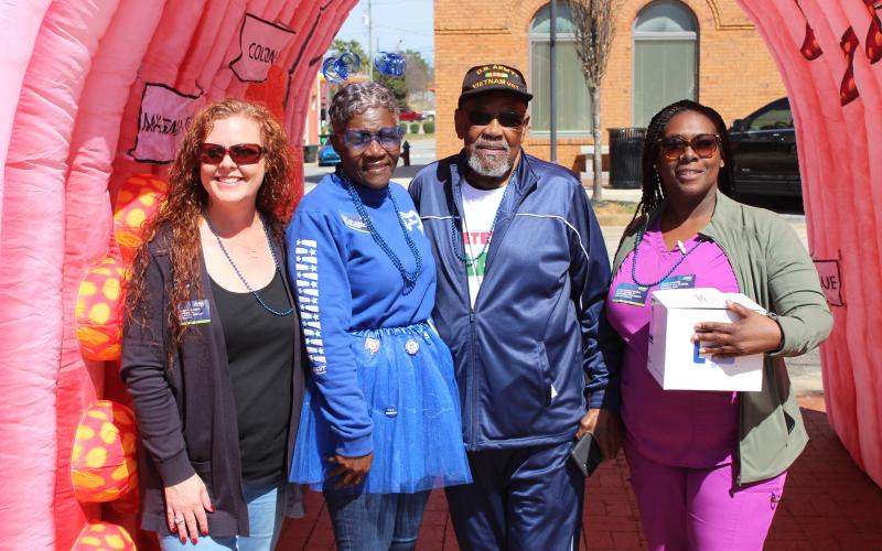 Brook McDowell, Pam Allen, Bobby G.Hunt and Yentil Almond stand outside the 8-foot educational inflatable colon from the University Cancer and Blood Center, an eye-opening educational tool illustrating what polyps and tumors look like. This display was part of the March 7 awareness event on the public square. (Photo submitted by Pam Allen)