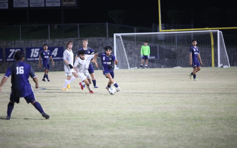 Andres Paita dribbles by a Commerce defender. (Photo by Wells)