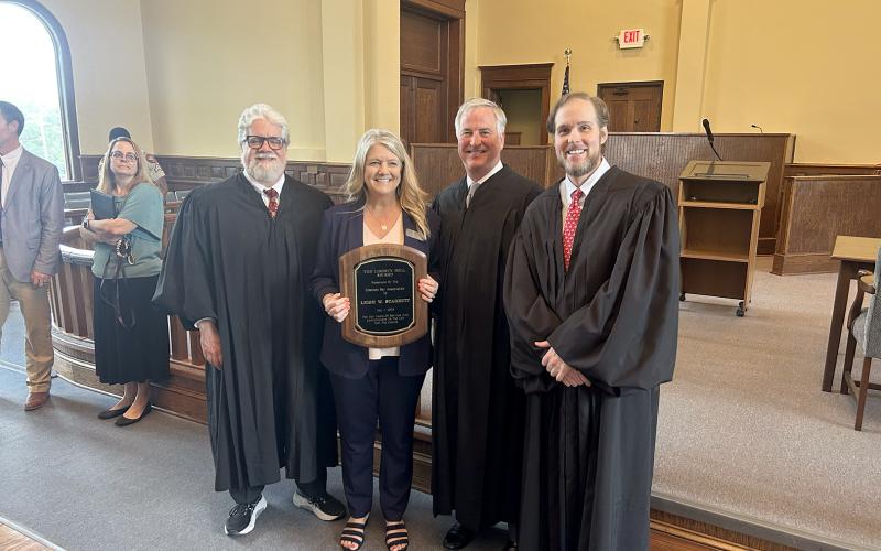 Elbert County Clerk of Courts Leigh Starrett was presented with the Liberty Bell Award by the Elberton Bar Association during a special session of the Court of Appeals of Georgia at the Elberton Courthouse. Pictured with the award are (L-R) Court of Appeals Presiding Judge Christopher J. McFadden, Starrett, Judge Kenneth Hodges III and Judge Trea Pipkin. (Photo by Wells)