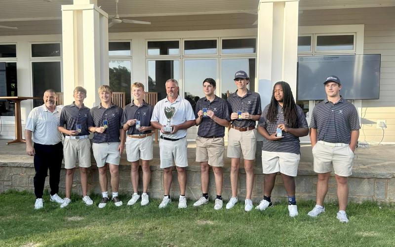 (L-R) Coach Sandy Thornton, Carson Amabile, Kale Kurtz, Madden Drake, Head Coach Larry Kesler, Nolan Henderson, Landen Adams, Caleb Burton and Brayden Edwards pose with the GHSA Golf State Championship trophy after finishing first in the state at Arrowhead Pointe May 19 and May 20. (Photo courtesy of Elbert County Golf)