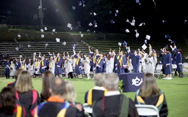 The Elbert County Comprehensive High School Class of 2025 throws their graduation caps in the air after Superintendent Robert Wheeler declares their graduation from high school education. (Photo by Wells)