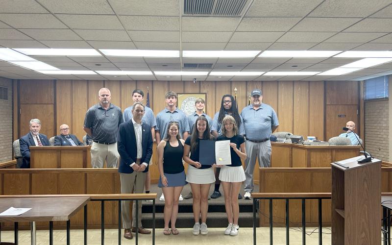 Pictured with the proclamation are (front row, L-R) Elberton Mayor Daniel Graves, Coach Emalise Andrews, Sophie Lavender, Camdyn Moon and (back row, L-R) Head Coach Larry Kesler, Nolan Henderson, Brayden Edwards, Carson Amabile, Caleb Burton and Coach Sandy Thornton. (Photo by Wells)