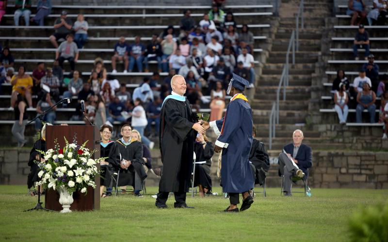 Jermaine Sims is presented with the Principal's Cup by ECCHS Principal Josh Rider. (Photo by Wells)