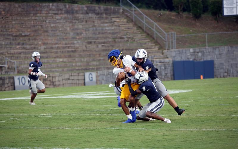 No. 2 Lincoln Blackmon and No. 9 Braylen Huff bring down the Washington-Wilkes quarterback during Elbert’s win in a scrimmage against the Tigers Aug. 1. (Photo by Bo Underwood)