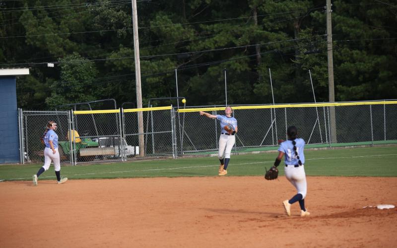 Audrey Lunsford rockets the ball towards home plate during Elbert’s win over Lincoln County Aug. 14. (Photo by Bo Underwood)