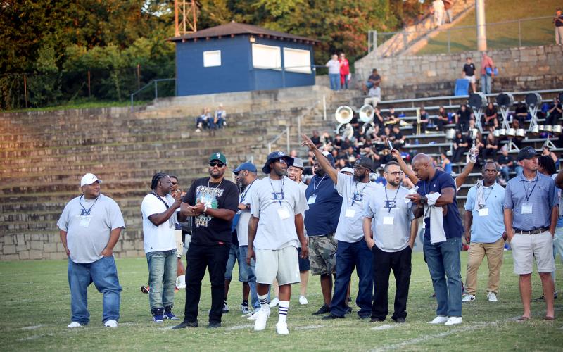 Members of Elbert County’s 1995 state championship football  team reunite on the field before the Blue Devils’ homecoming game against Oglethorpe on Sept. 19. (Photo by Bo Underwood)