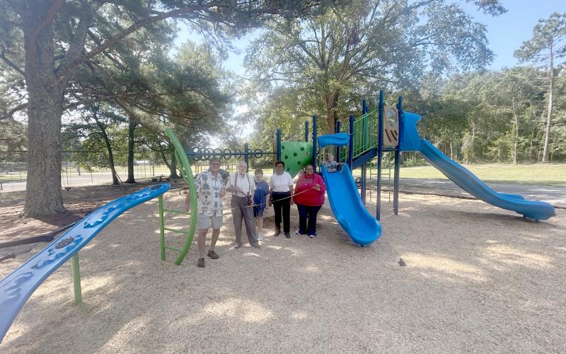 Mayor Scott Harpold, John Beucler, Lera Ray, council member Henrietta Maxwell and city clerk Tiffany Verdell pose at the ribbon cutting for Bowman's new playground. (Photo by Mark Wells)