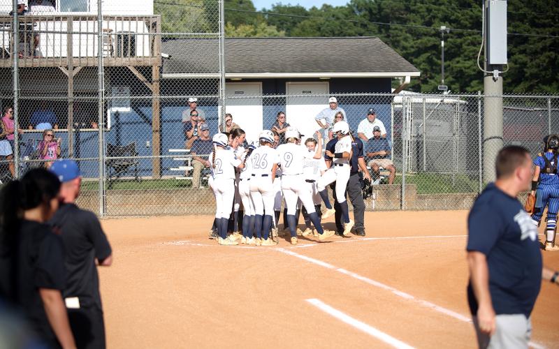 Teammates celebrate with  junior catcher Ky Dubose after a 3-run home run against Banks County. (Photo by Bo Underwood)