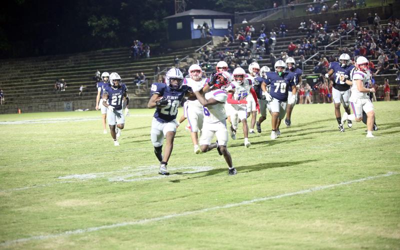 Tyler Turman stiff arms a defender against Oglethorpe on Sept. 19. (Photo by Bo Underwood)