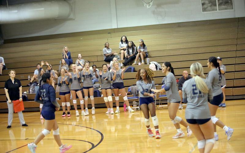 Trania Skelton (2) and Alexia Vargas (far right) celebrate after a point in Elbert’s match against Rabun County on September 3. (Photo by Bo Underwood)