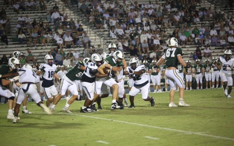 A host of Devils wrap up a Wesleyan ballcarrier during Elbert’s 14-7 loss Aug. 29. (Photo by Bo Underwood)