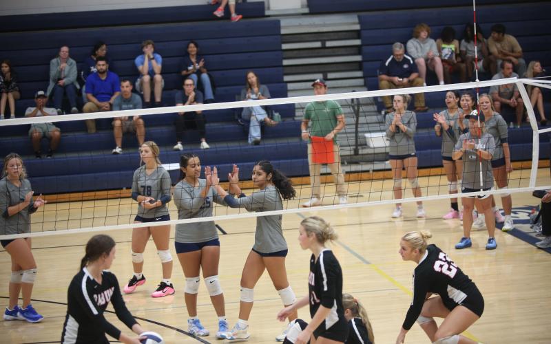 Melanie Badillo (left) and Alexa Vargas (right) high five after a victory over Rabun on Sept. 16. (Photo by Bo Underwood)
