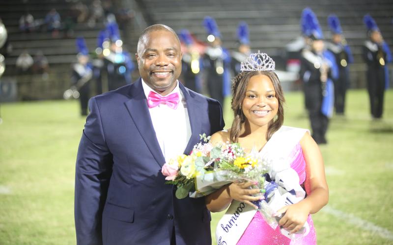 Jaslyn Huff (right) sports her homecoming queen crown alongside her father Jasper Huff (left) . (Photo by Bo Underwood)