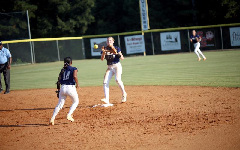Elbert County teammates Kimberly Hernandez (14) and Audrey Lunsford (9) execute a force out in the Lady Devils’ 10-2 win over Providence Christain on Sept. 23. (Photo by Bo Underwood)