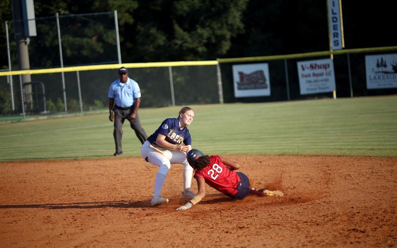 Audrey Lunsford (left) attempts to tag a runner out at second base. (Photo by Bo Underwood)