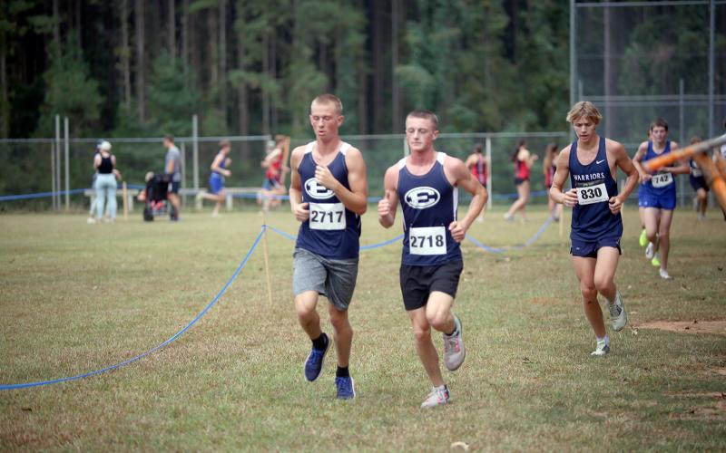 Devils Tommy Beahringer and Ezra Adamson run neck-and-neck at the Granite City Invitational. Beahringer and Adamson were the Devils’ Top 2 finishers. (Photo by Bo Underwood)