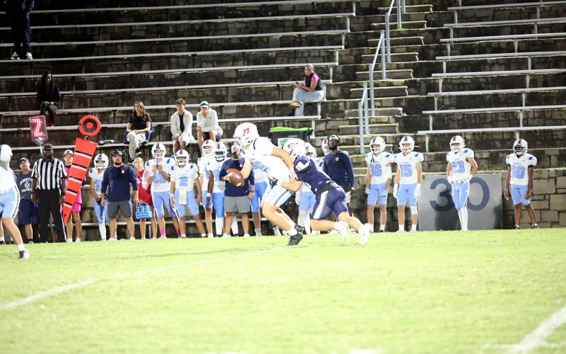 Brycin Hughes (18) brings the quarterback down for a sack in Elbert’s 43-9 win over Providence Christian. (Photo by Bo Underwood)