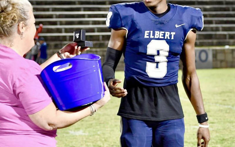 Triple jump state champion D.K. Winn smiles as he recieves his championship ring from athletic director Jeannie Jourolmon. (Photo courtesy of Elbert County True Blue)