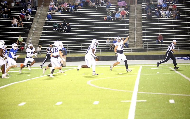Jerrell Sims (left) returns a fumble for a touchdown on the opening play of Elbert’s game at Banks County on Oct. 10. (Photo by Bo Underwood)
