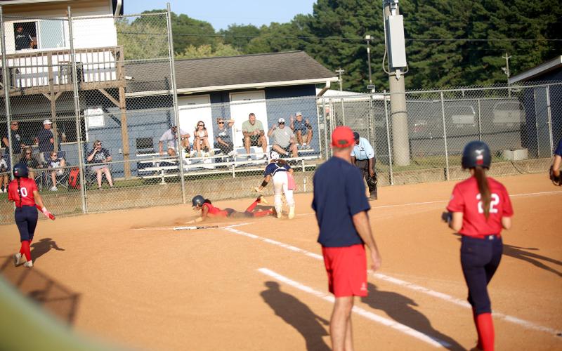 Ky Dubose (11) tags the runner out at home after a long throw from outfielder Kamryn Webb. (Photo by Bo Underwood.)