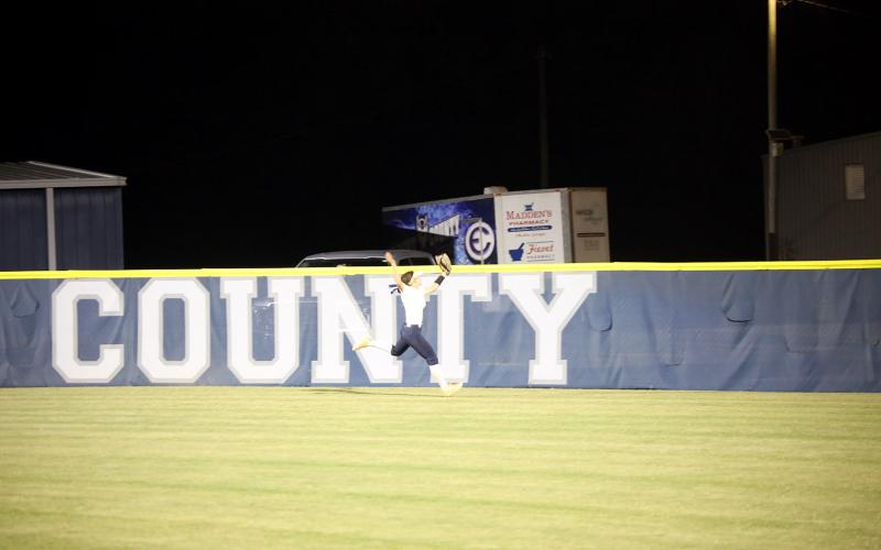 Bellamy Nash leaps to make a catch in the outfield. (Photo by Bo Underwood)