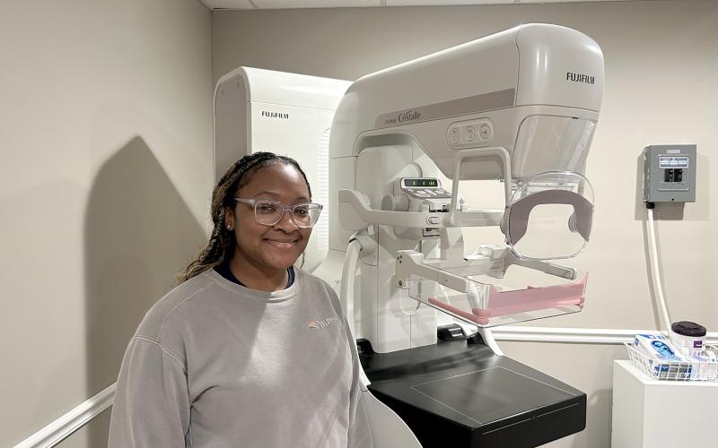 Mammography technician Alayjah Sammons poses with the Fujifilm ASPIRE Cristalle, a state-of-the-art mammography machine that is available for patients at Elbert Memorial Hospital.