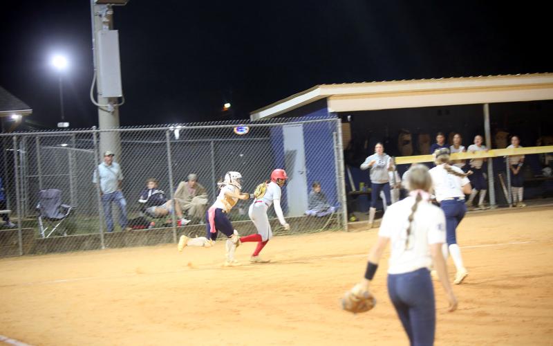 Ky Dubose (11) tags a runner out. (Photo by Bo Underwood)