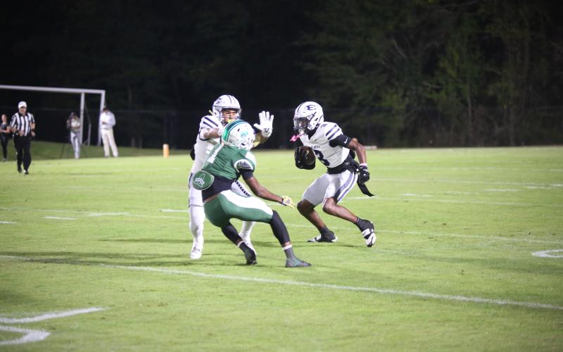 D.K. Winn (3) gets a block from Jose Rodriguez in Elbert’s 48-14 loss to Athens Academy on Oct. 17. (Photo by Bo Underwood)