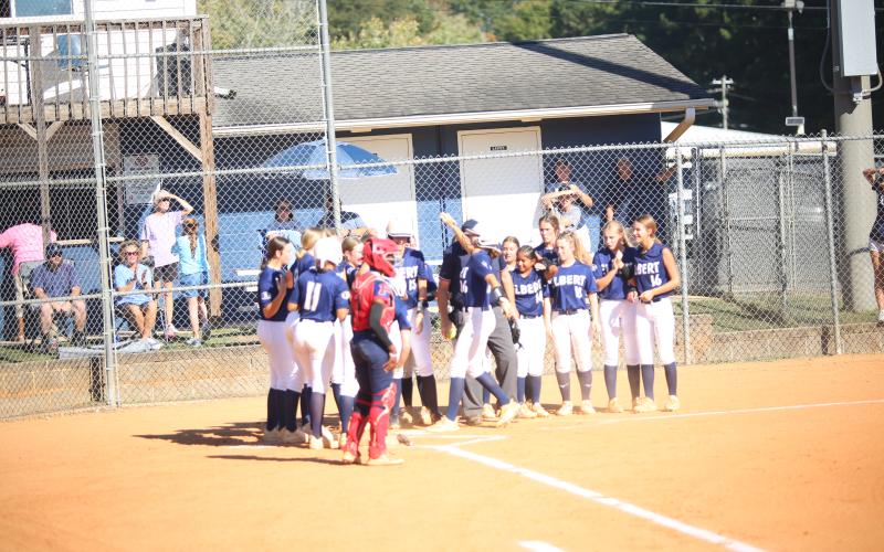 Kamryn Webb (26) crosses the plate and celebrates with teammates after hitting a home run in Elbert’s 15-0 win over Putnam County on Oct. 15. (Photo by Bo Underwood)