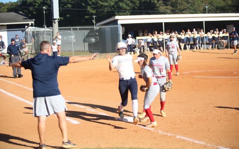 Bryleigh Dickerson (13) makes it to first base in a close play. (Photo by Bo Underwood)