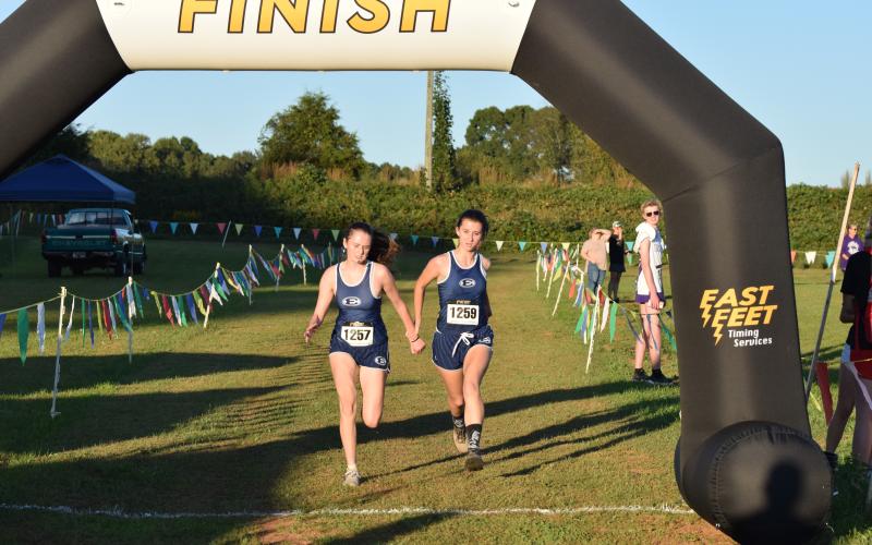 Marley Geyer (left) and Kennedy Ray finish side-by-side at the Jan Taylor Invite at Franklin County High School on Oct. 16. (Photo courtesy of Shane Scoggins / The Franklin County Citizen)