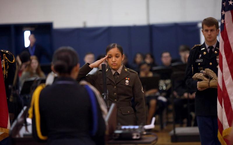 ECCHS JROTC cadet Isabel Cruz salutes during the ECCHS Veteran's Day program Nov. 11. (Photo by Bo Underwood)