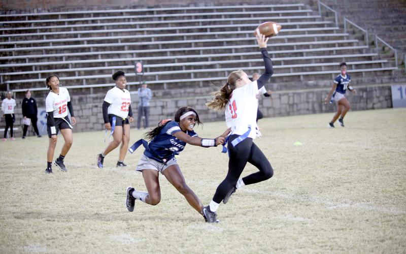 Nakenya Wiley (6) pulls the flag of the Cedar Shoals quarterback as she throws a pass. (Photo by Bo Underwood)