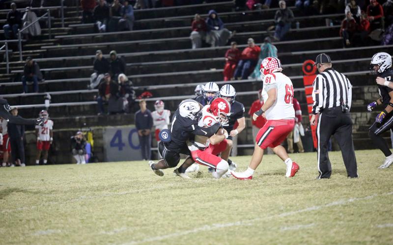 Reunte Tucker (1) brings down the quarterback. (Photo by Bo Underwood)