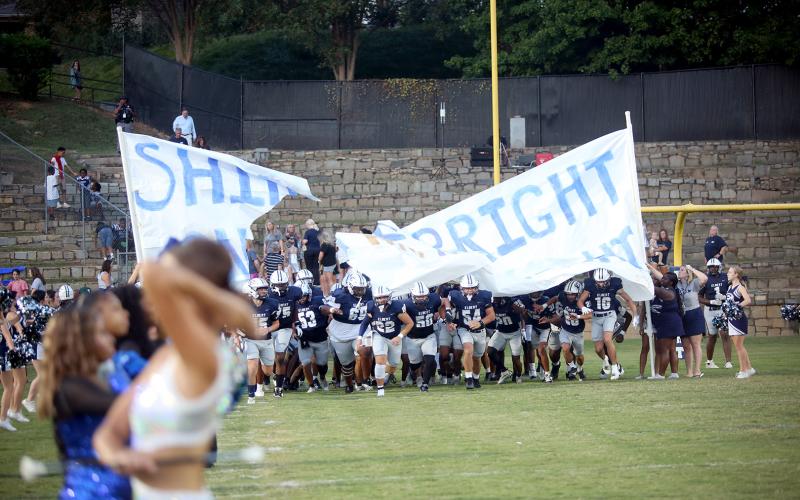 The Elbert County football team runs through the banner before their homecoming game against Oglethorpe on Sept. 19. (Photo by Bo Underwood)