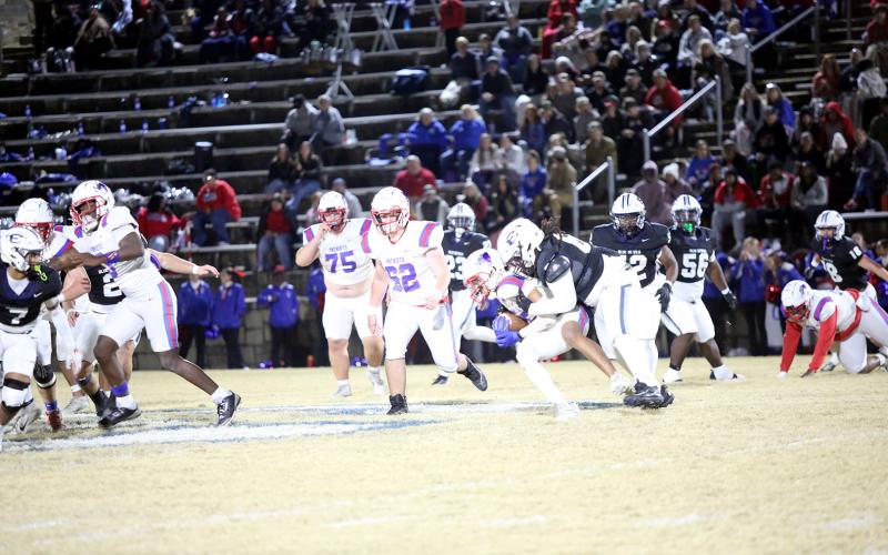 Chance Ardister brings down the ballcarrier in the backfield. (Photo by Bo Underwood)