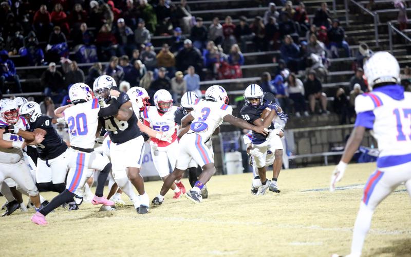 Tyler Turman muscles through a tackle. (Photo by Bo Underwood)