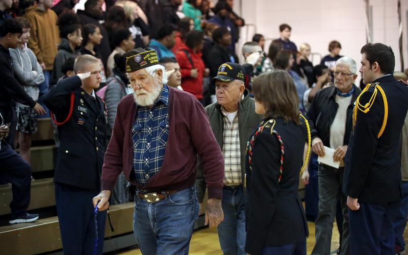 Elbert County Comprehensive High School (ECCHS) JROTC cadets render a hand salute as veterans make their way into the ECCHS gym for the school's annual Veteran's Day program. (Photo by Bo Underwood)