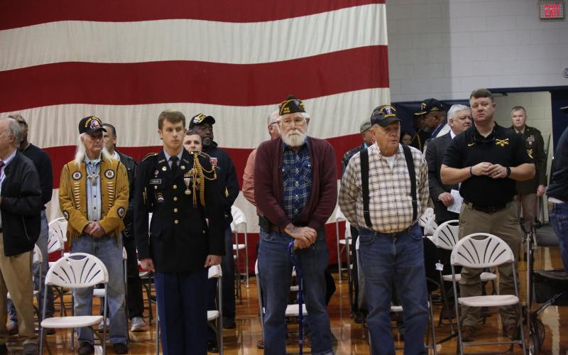 Veterans stand up to be recognized at ECCHS' annual Veteran's Day program. (Photo by Bo Underwood)