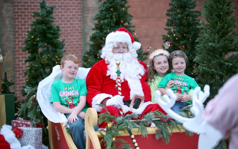Children sit with Santa at Elberton's Candlelight Shop Night on Nov. 25. (Photo by Mark Wells)
