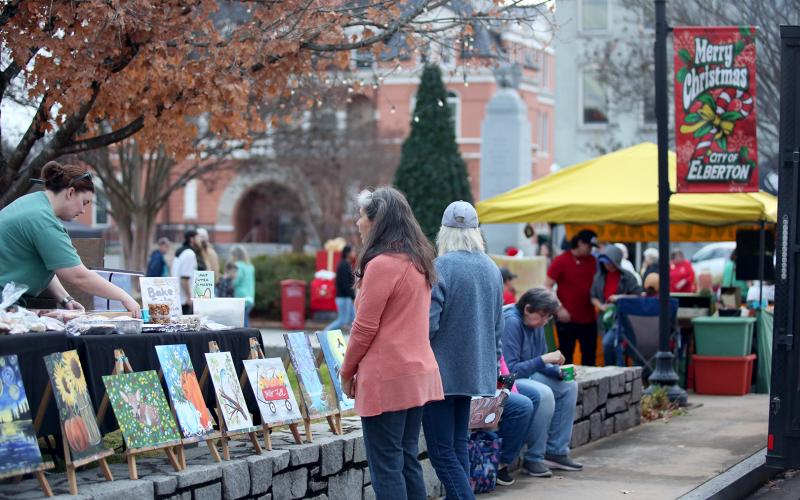 A woman shops for art  at Elberton's Candlelight Shop Night on Nov. 25. (Photo by Mark Wells)