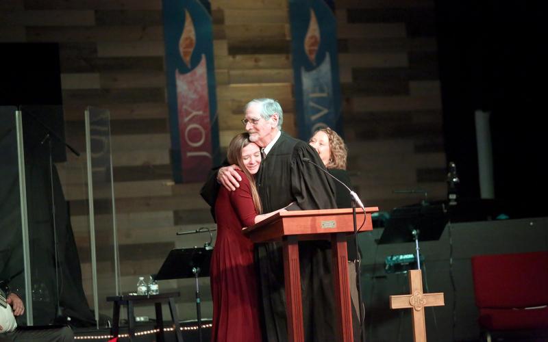 Judge Chris Phelps hugs a recent graduate of the Northern Judicial Circuit's Felony Drug Court. (Photo by Mark Wells)